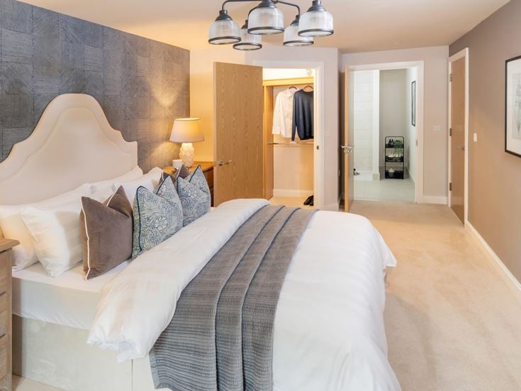 a bedroom with a bed and lamps