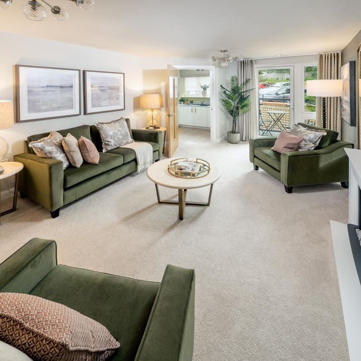 a living room with green couches