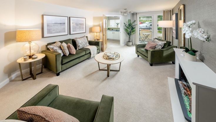 a living room with green couches