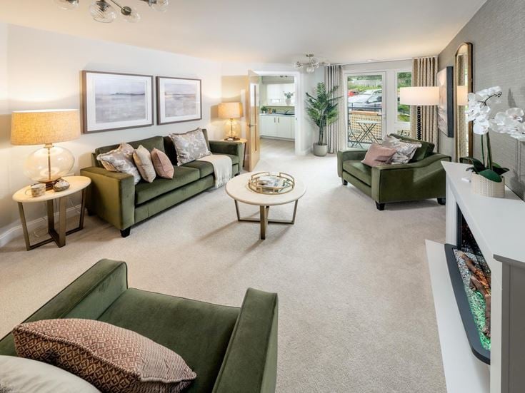 a living room with green couches