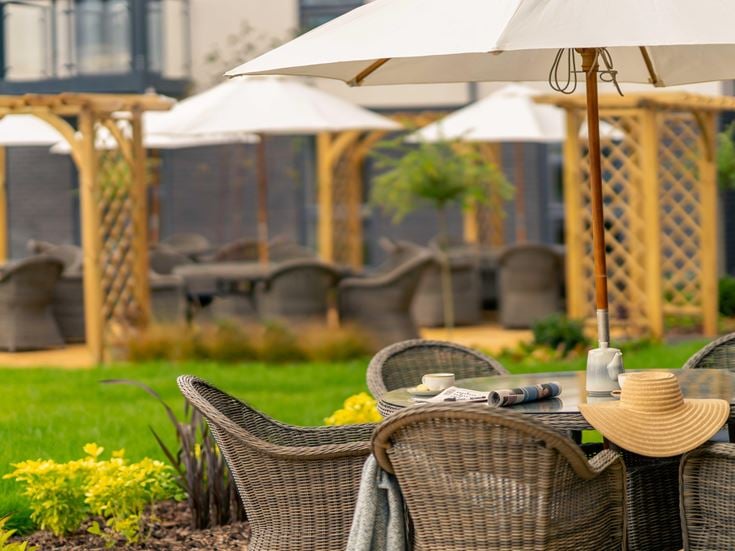 a table with chairs and umbrellas