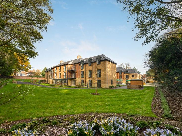 a large house with a pond in front of it