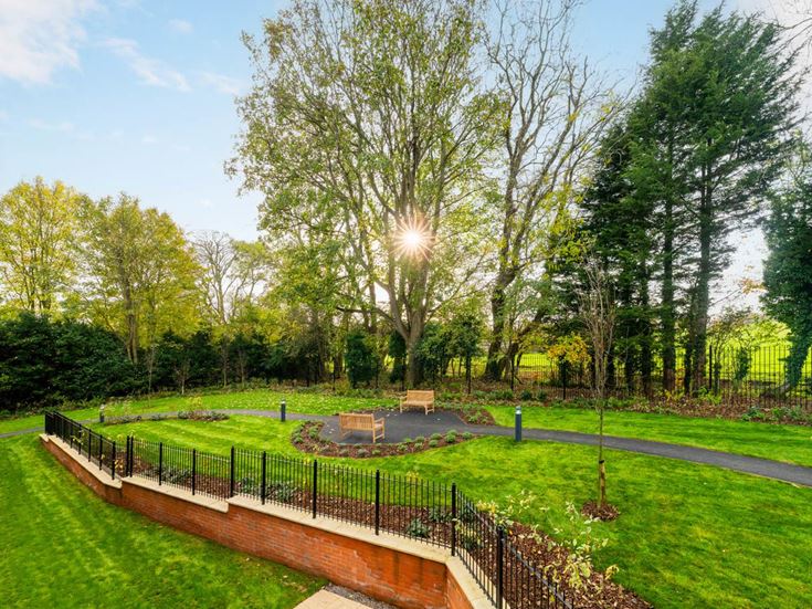 a park with a fence and trees