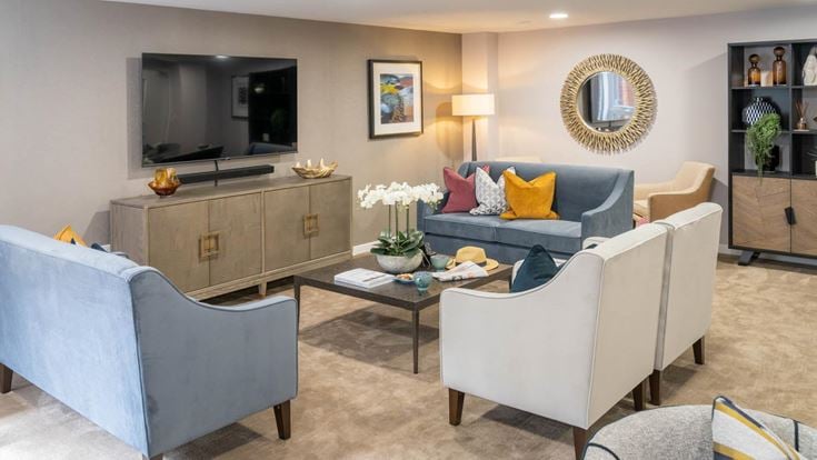 a living room with a tv and couches
