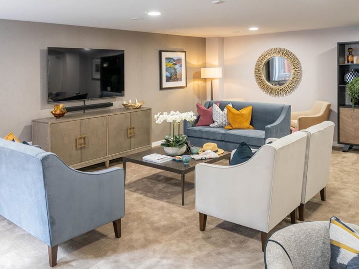 a living room with a tv and couches