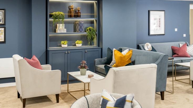 a living room with a blue wall