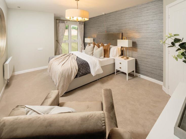 a large bedroom with a bed and couches