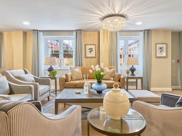 a living room with a large chandelier and a large glass table