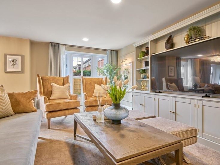 a living room with a table and chairs