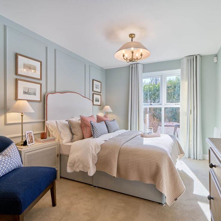 a bedroom with a bed and a chair