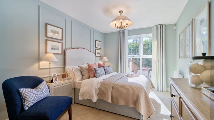 a bedroom with a bed and a chair