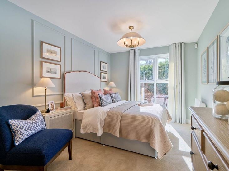 a bedroom with a bed and a chair