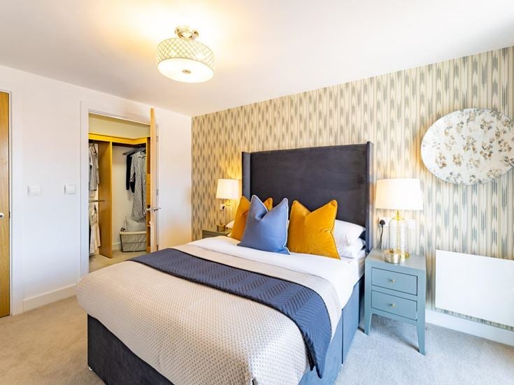 a bedroom with a bed and lamps