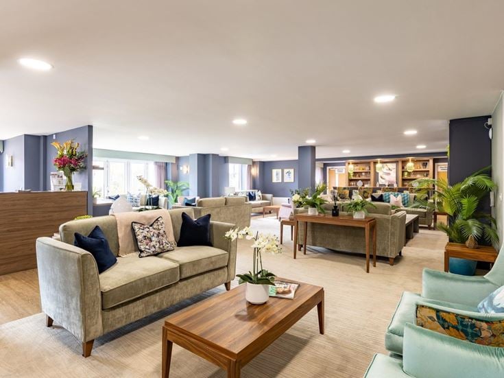 a living room with a couch and chairs