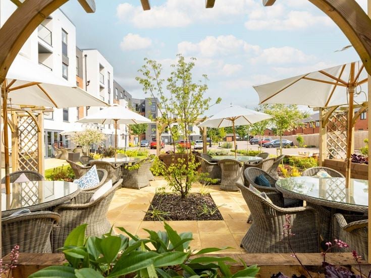 a patio with umbrellas and chairs