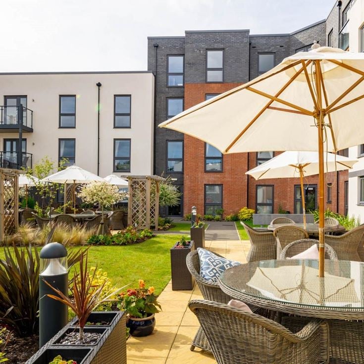 a patio with chairs and umbrellas