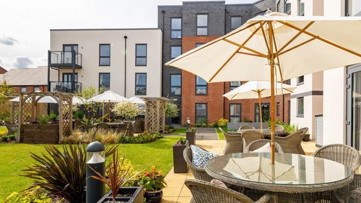 a patio with chairs and umbrellas