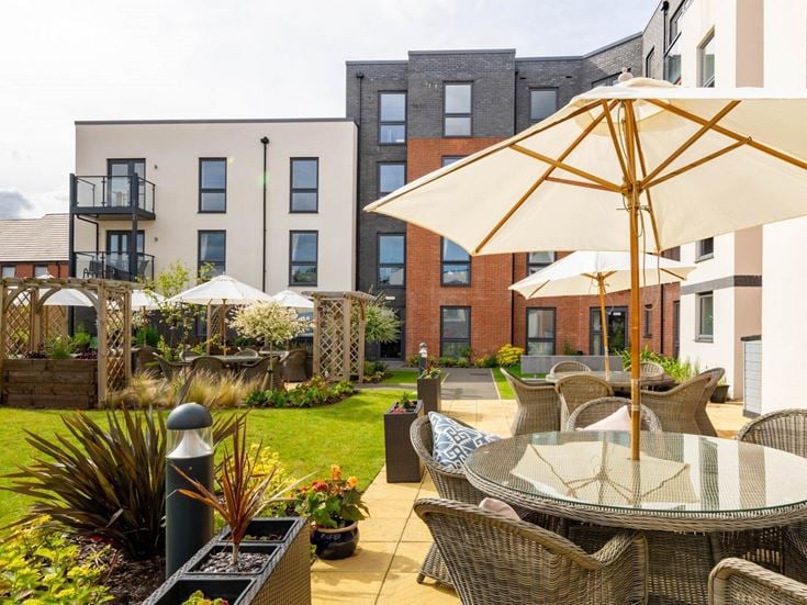 a patio with chairs and umbrellas