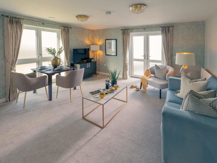 a living room with a table and chairs