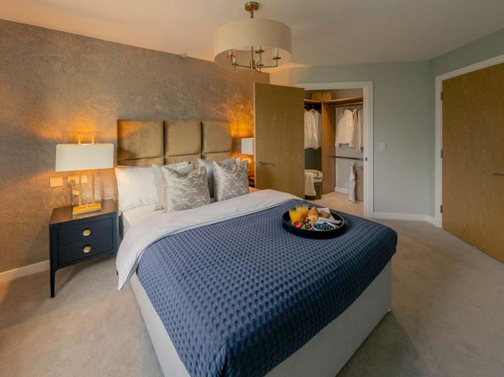 a bed with a blue sheet