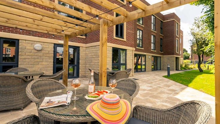 a patio with a table and chairs
