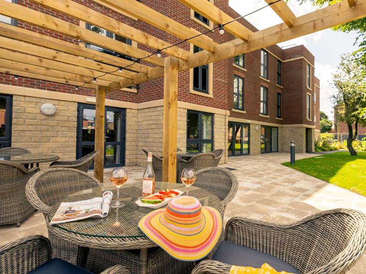 a patio with a table and chairs