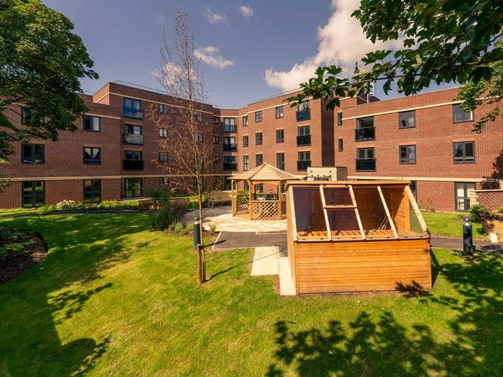 a small wooden structure in front of a brick building