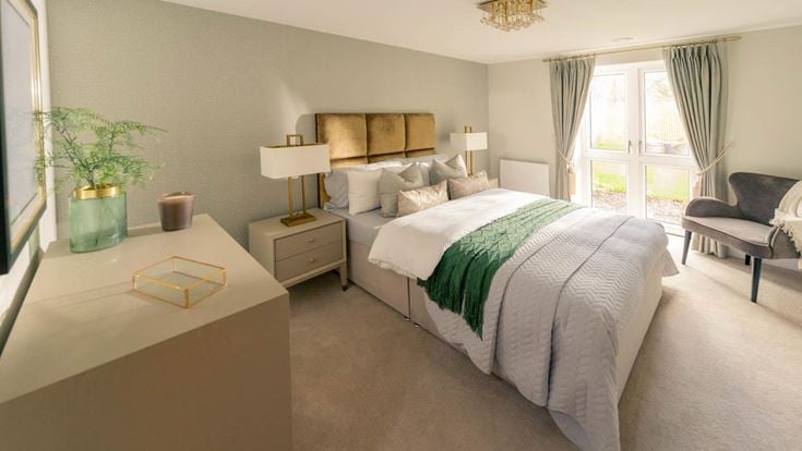 a bedroom with a bed and a desk
