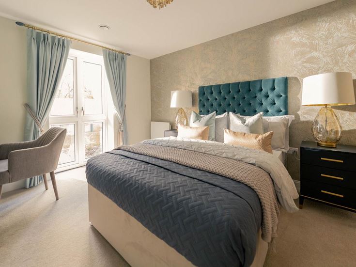 a bedroom with a bed and a chair