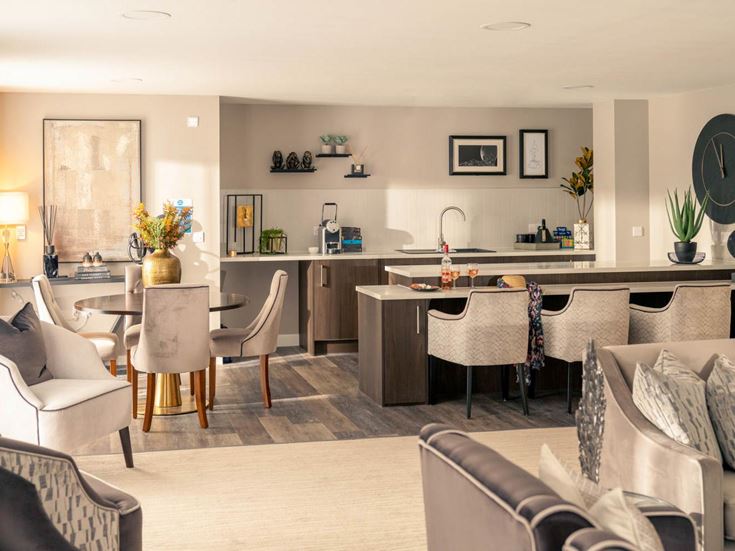 a large living room with white furniture