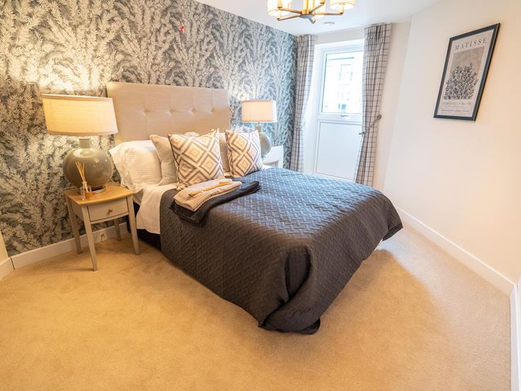 a bedroom with a bed and lamps