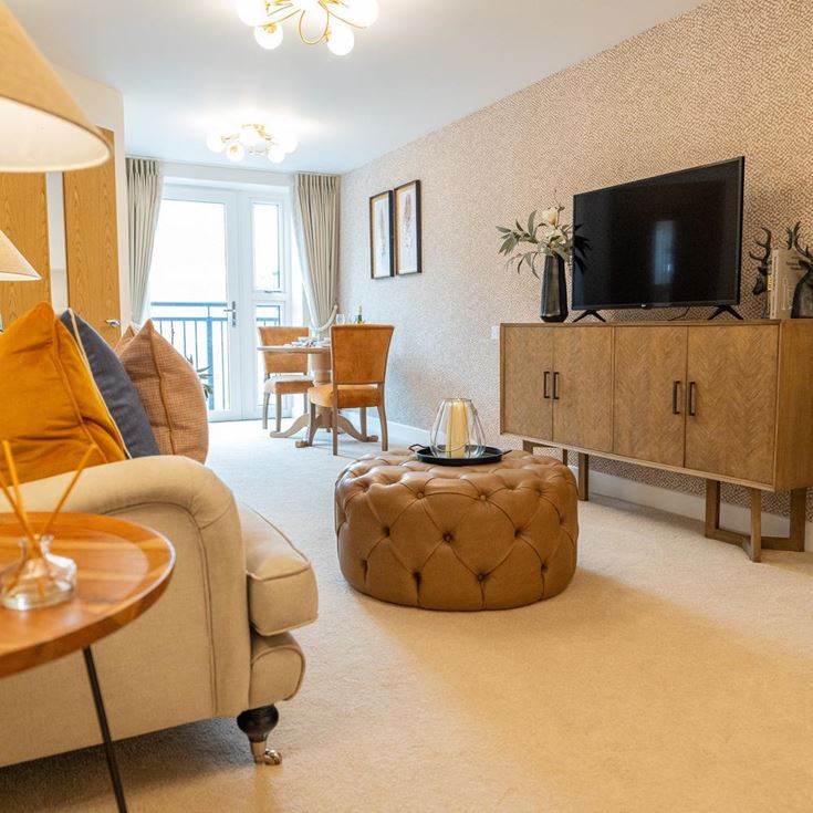 a living room with a tv and furniture