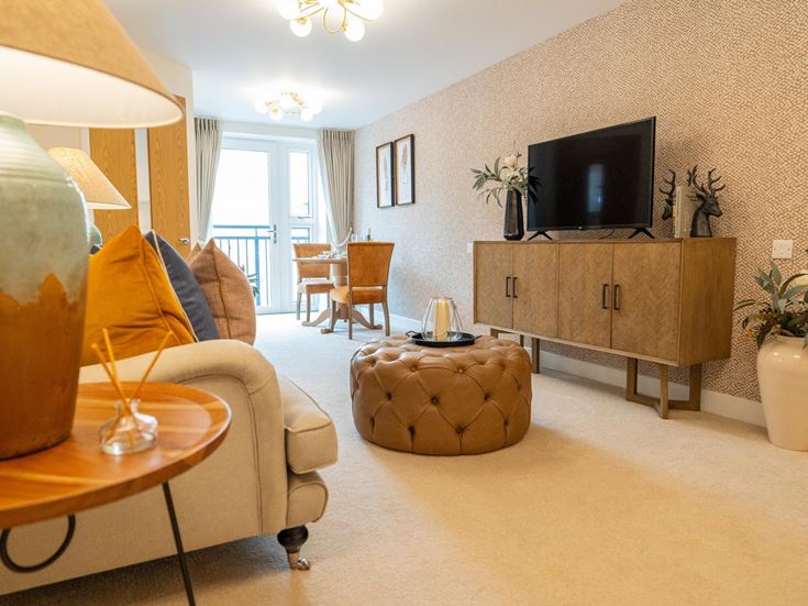 a living room with a tv and furniture