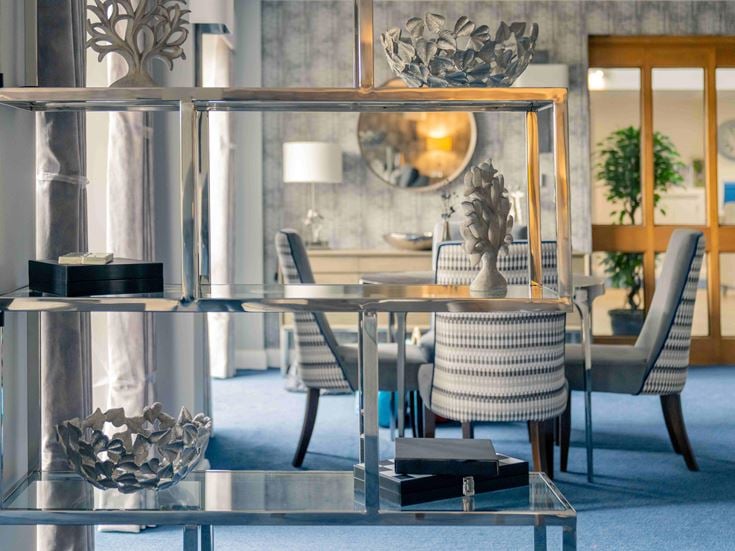 a table with chairs and a statue