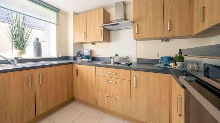 a kitchen with wooden cabinets