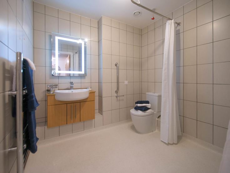a bathroom with a sink toilet and mirror