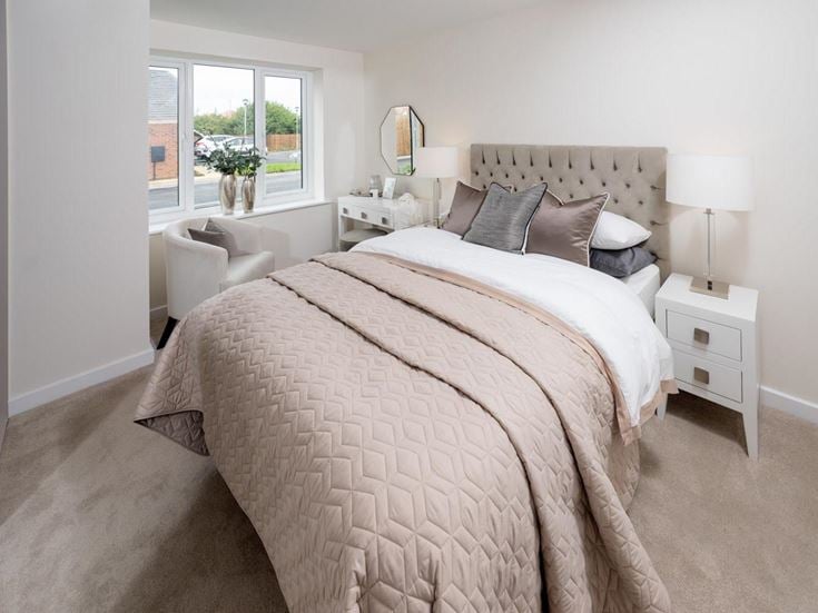 a bedroom with a bed and a chair
