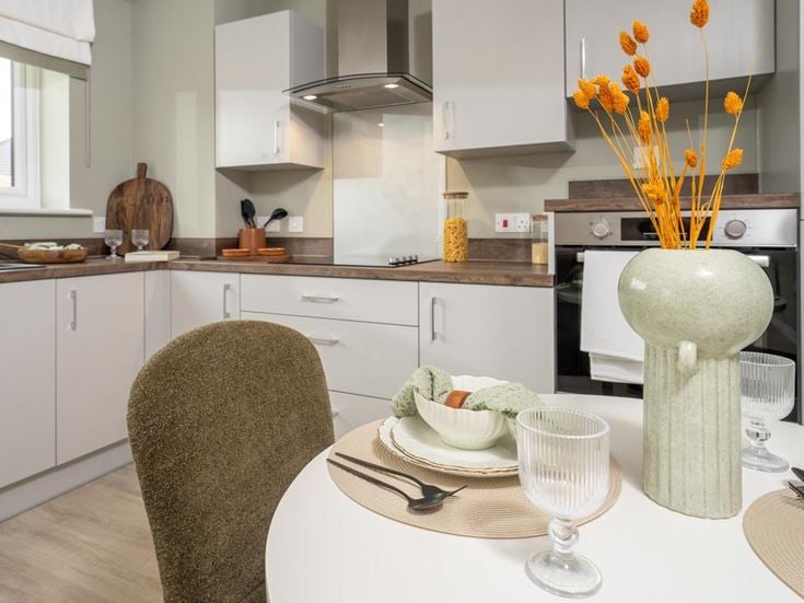 a kitchen with a table and chairs