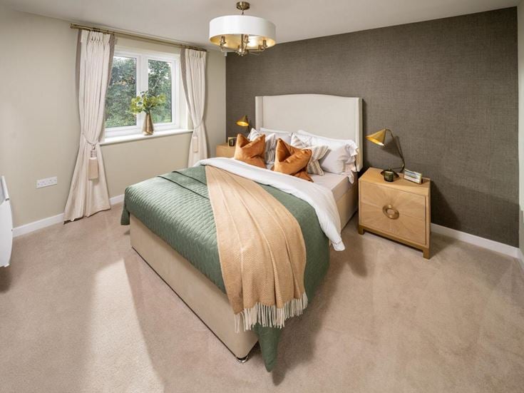 a bedroom with a bed and a lamp