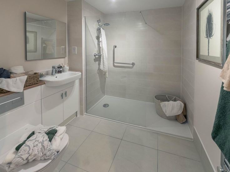 a bathroom with a tub sink and towels