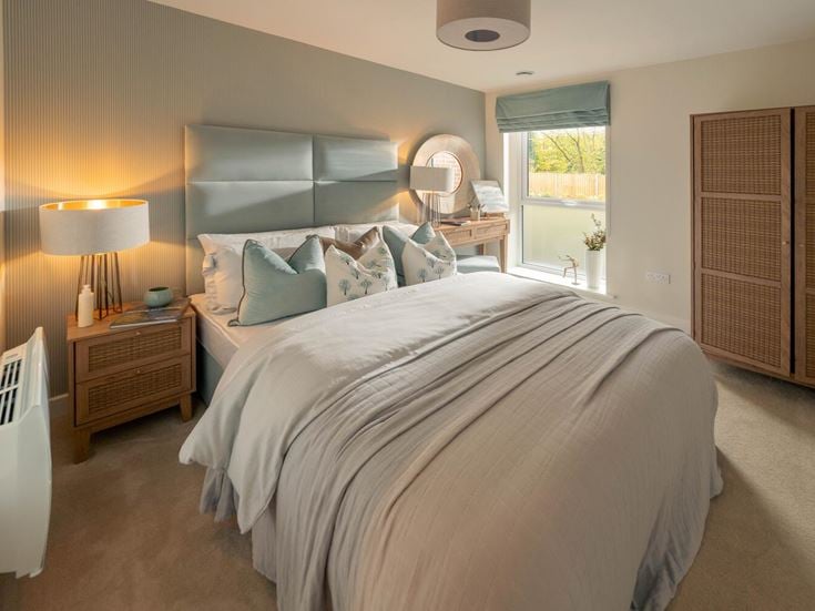 a bedroom with a bed and a lamp