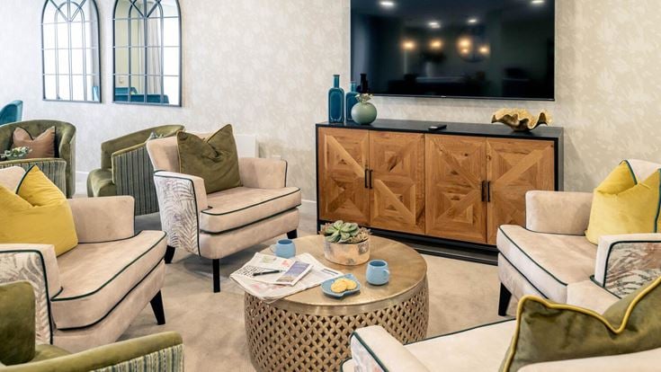 a living room with a tv and couches