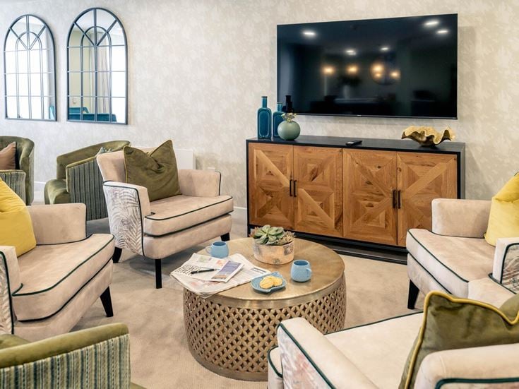 a living room with a tv and couches