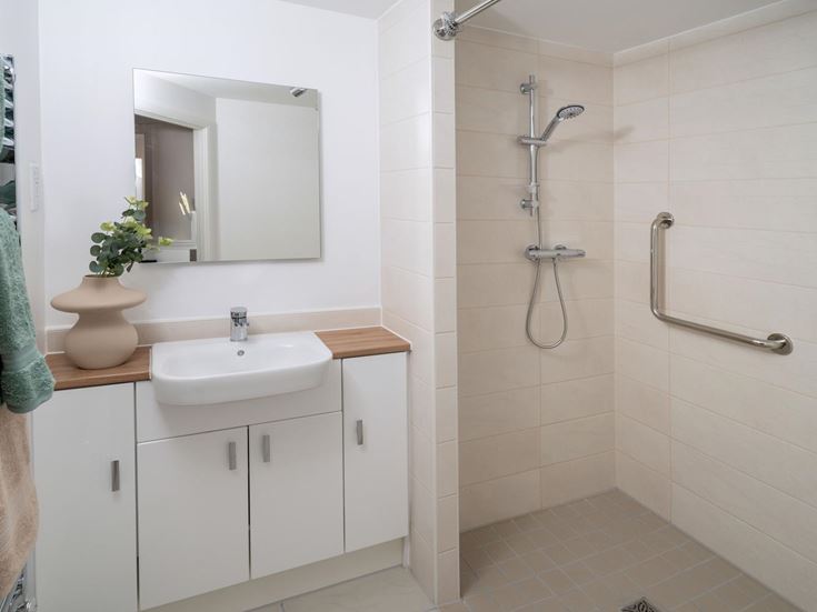 a bathroom with a shower and sink