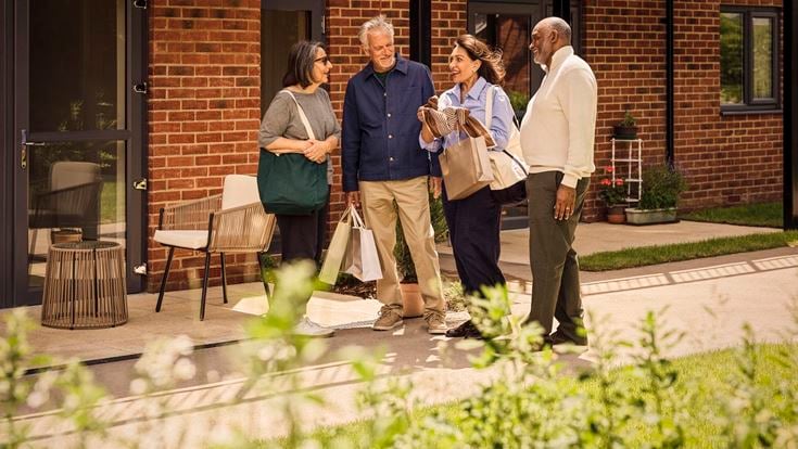 a group of people standing outside a brick building