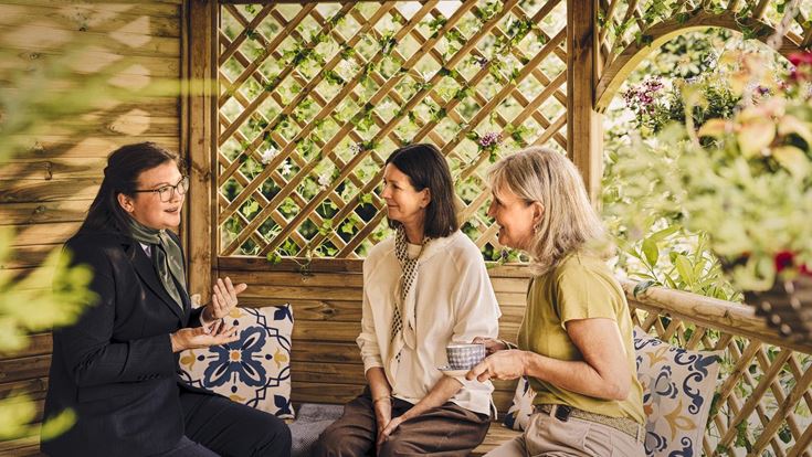 a group of women sitting on a bench
