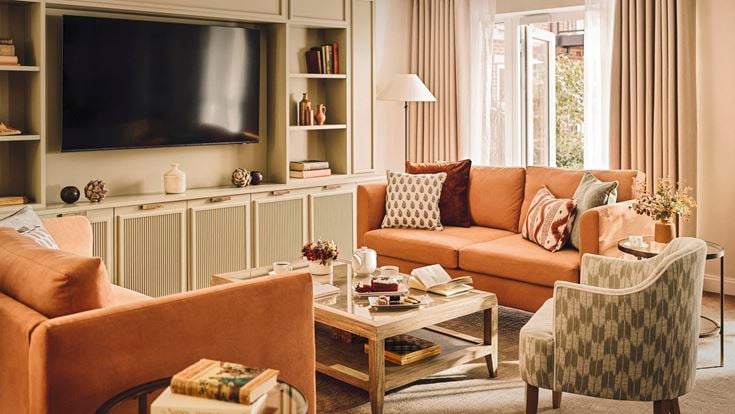 a living room with a tv and couches