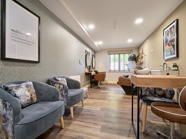 a living room with a table and chairs