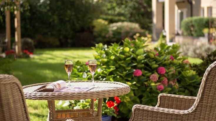 a table with wine glasses and flowers on it