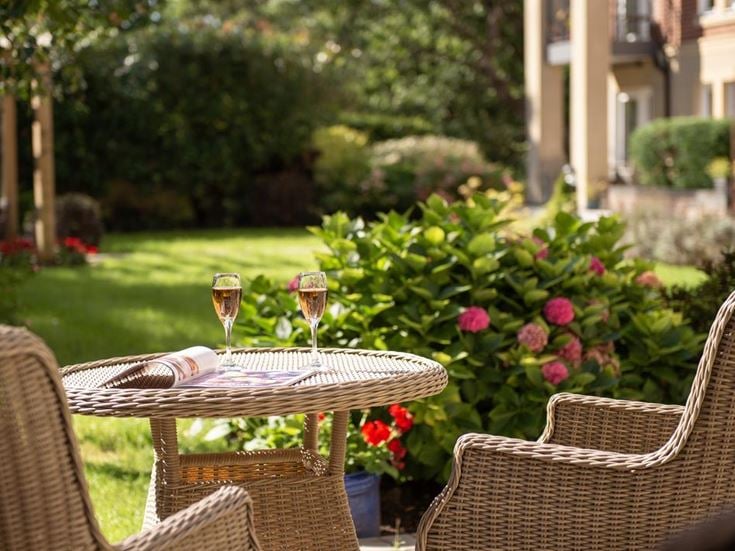 a table with wine glasses and flowers on it